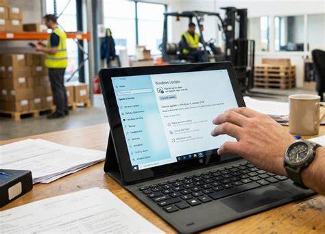 A person is reading articles about Windows update misconceptions on a tablet.
