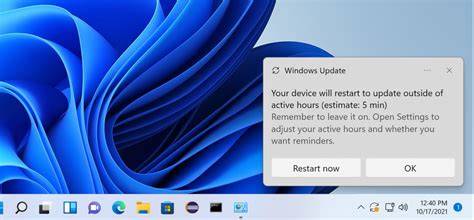 A Windows 11 laptop displaying an update notification message